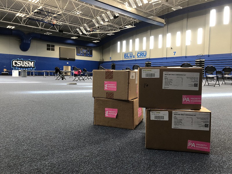 Four boxes of medical supplies are stacked on the ground of the Cal State Uni...