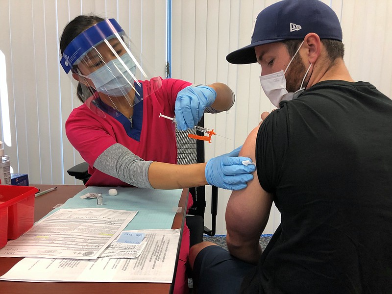 A man gets the COVID-19 vaccine at San Diego County's 