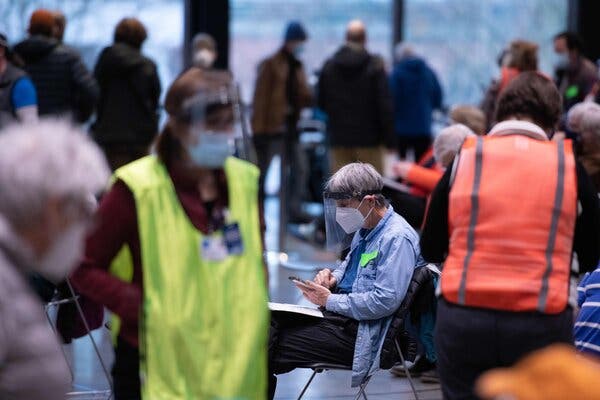 Patients are observed for adverse reactions after receiving their first Covid-19 vaccine doses in downtown Seattle last month. Scheduling the next dose has not always been a streamlined process.