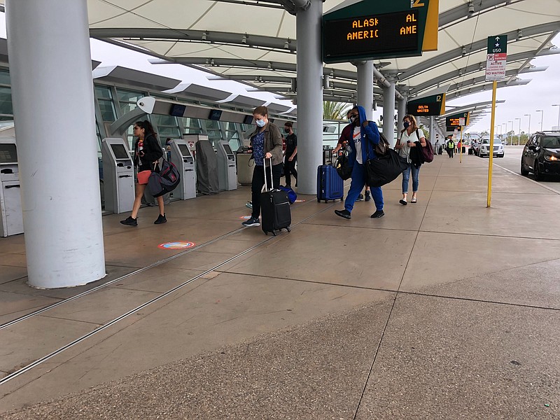 Passengers head to planes at the San Diego International Airport on June 24, ... Passengers head to planes at the San Diego International Airport on June 24, ...