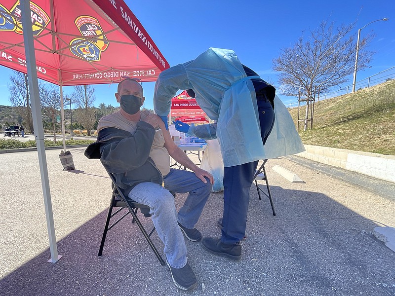 A man receives a COVID-19 vaccine from Cal Fire in Julian, Calif. Feb. 3, 2021.